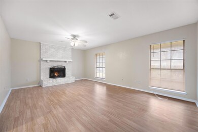 Large family room with light wood finished floors,