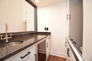 The wet bar connects to the living room and dining