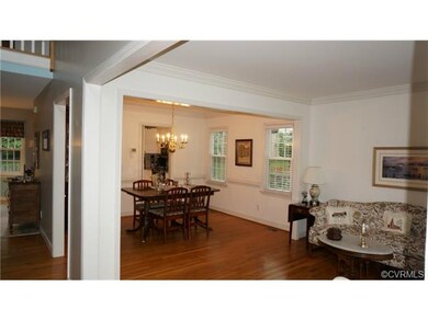 Living and dining room with detailed moldings, gre