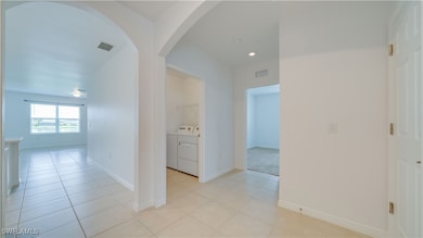 Hallway featuring independent washer and dryer, ar