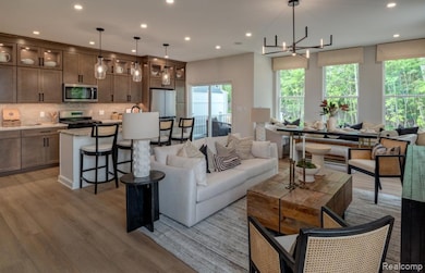 Living area with light wood-type flooring, recessed lighting, and a chandelier