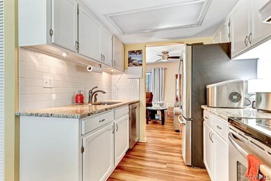 Kitchen with dishwasher, white cabinets, tasteful