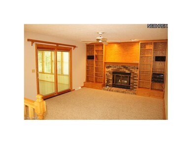family room with built in bookshelves and woodburn
