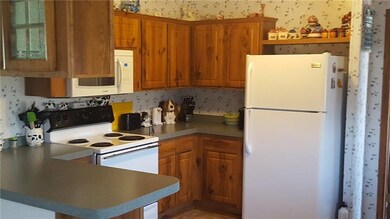 Kitchen features a small bar and plenty of cabinet