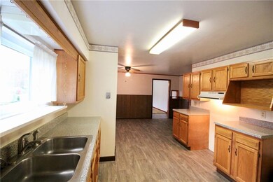 Open kitchen and dining area with new flooring.