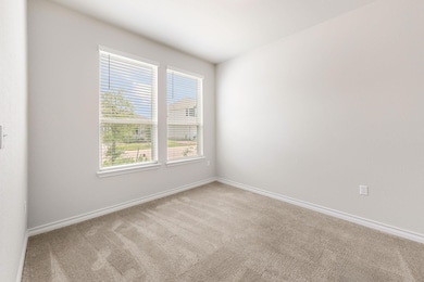 Carpeted spare room with baseboards