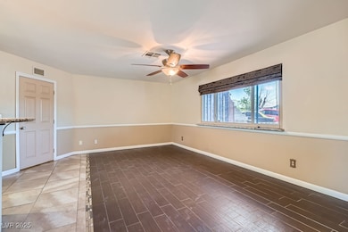 Unfurnished room featuring ceiling fan and wood fi