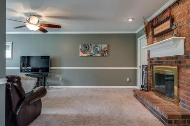 The brick fireplace in the den provides character.