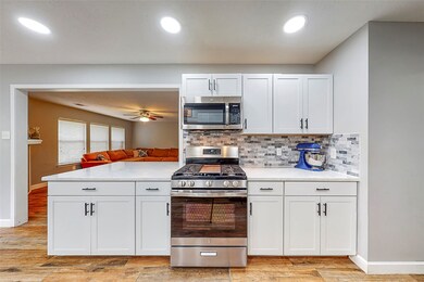 Kitchen recently remodeled with stainless appliances, marble coutertops, cabinetry, canned lighting and gas cooking.