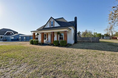 View of front of house with a front lawn and a por