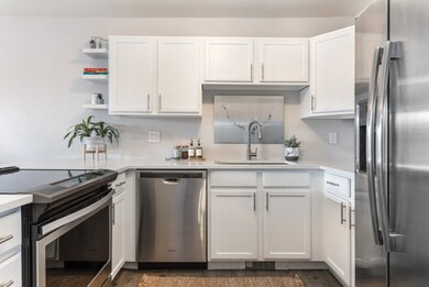 Kitchen with stainless steel appliances, wood-type