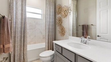 Accessible off the hallway is a full-sized bathroom with a shower and tub combination.