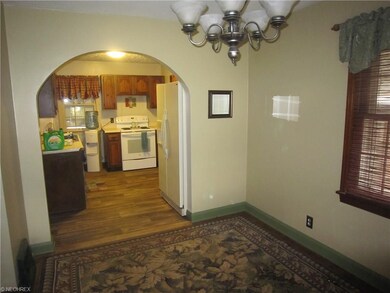 Dining room with charming arched doorway leading i