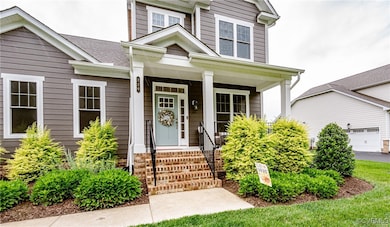 Property entrance with covered porch and roof with