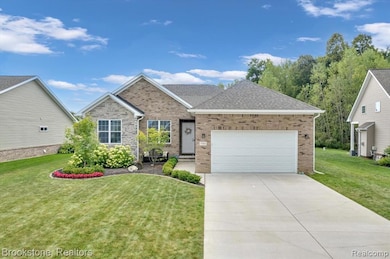 View of front of property featuring an attached garage and brick siding