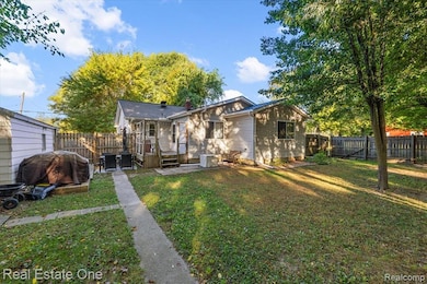 Back of property featuring a patio, a fenced backyard, and a chimney