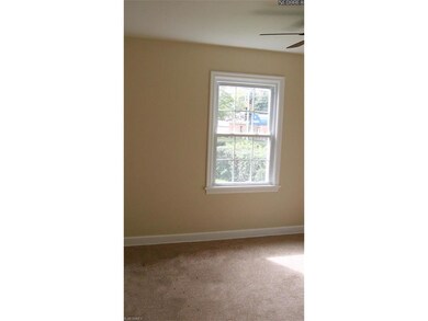 one of two first floor bedrooms with neutral color