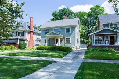 Colonial inspired home with a porch and a front lawn