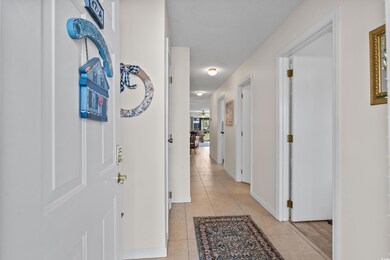 Corridor featuring light tile patterned floors and
