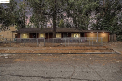 Single story home with a fenced front yard, concrete driveway, a garage, and roof with shingles