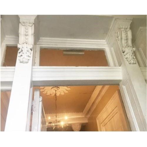 Corbels just inside the double entry doors are original as is the ceiling medallion above.