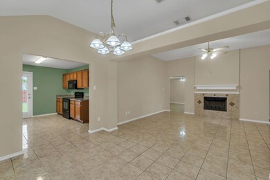Kitchen with visible vents, baseboards, a tiled fi