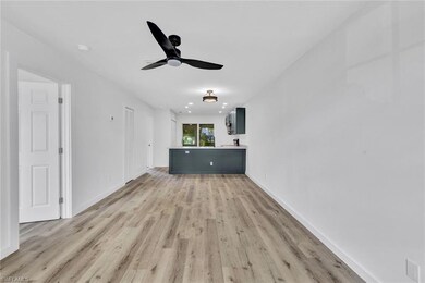 Unfurnished living room with baseboards, a ceiling