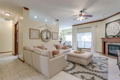 Living room featuring ceiling fan with notable cha