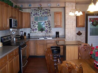 Kitchen has lots of oak cabinetry & plenty of coun