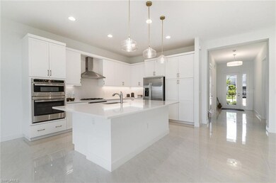 Kitchen featuring stainless steel appliances, wall