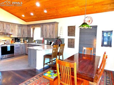 Kitchen featuring hanging light fixtures, stainles