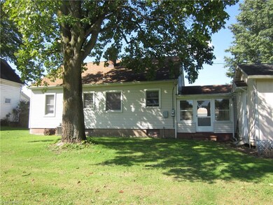Back of the home with the workshop to the right