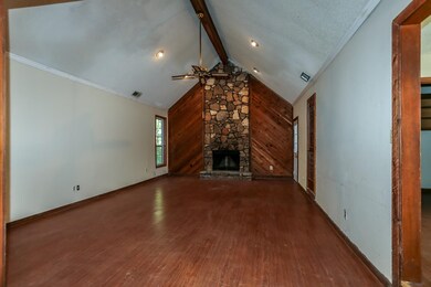 Unfurnished living room featuring vaulted ceiling 