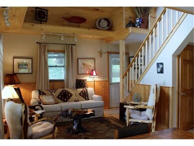 THIS WARM AND INVITING LIVING ROOM HAS A STAIRWAY 