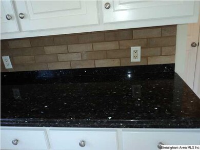 STONE COUNTERTOPS WITH BRICK TILE BACKSPLASH