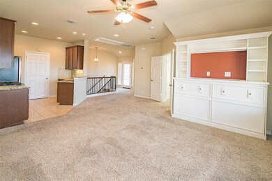 Kitchen featuring light colored carpet, a ceiling