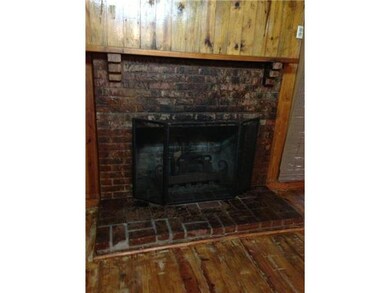 Wood-Burning Fireplace and Knotty Pine walls/ floo