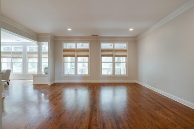 Unfurnished living room with decorative columns, b