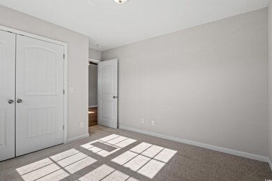 Unfurnished bedroom featuring light carpet and a c