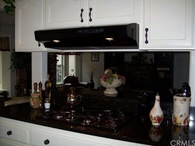 Propane gas cooktop and granite counters.  Open to