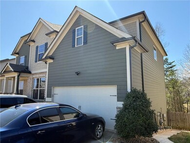 View of side of home with an attached garage and f