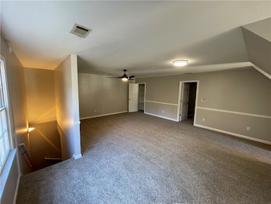Spare room featuring carpet flooring and a ceiling fan