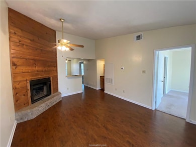 Unfurnished living room featuring ceiling fan, a b