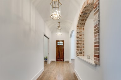 Enter to see generous sized hallway with coffer ce