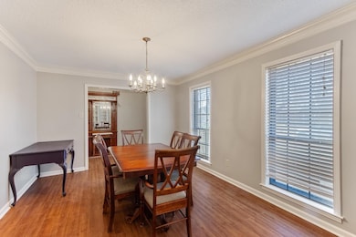 Dining space with ornamental molding, wood finishe