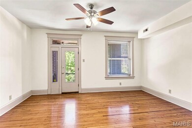 Living room with a man door leading to the balcony