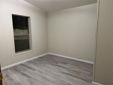 Empty room featuring light wood finished floors an