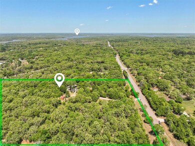 The home sits on 5 wooded acres just minutes from 