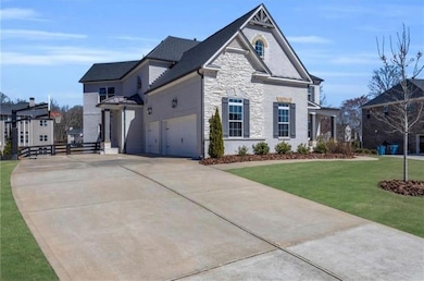 View of front of house with concrete driveway, sto