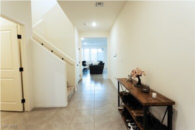 Hallway featuring stairs, light tile patterned flo
